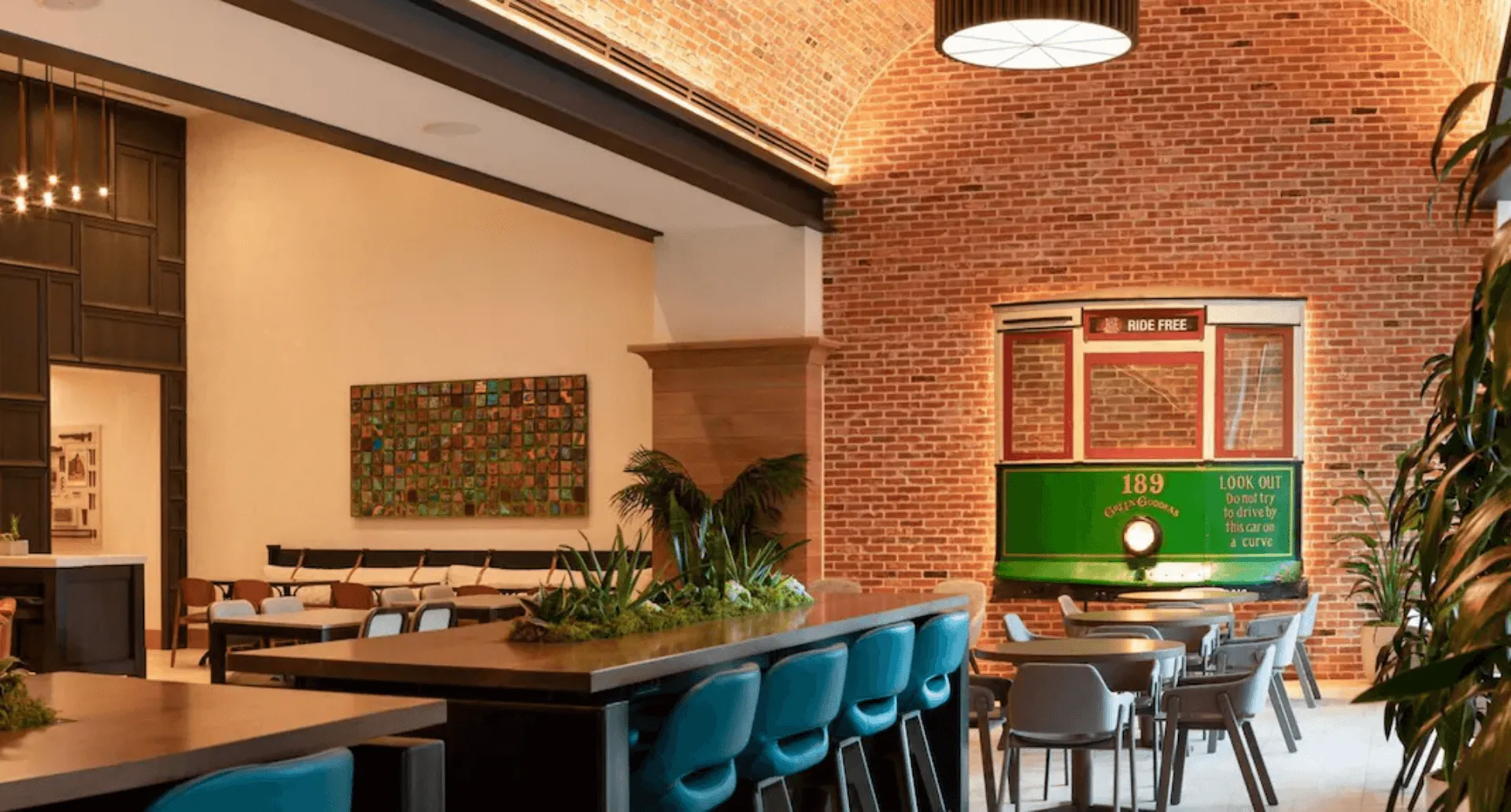 a dining area with a green trolley in the background